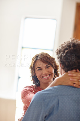 Buy stock photo Shot of a husband and wife sharing an affectionate moment at home