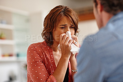 Buy stock photo Cropped shot of a woman crying in front of her husband