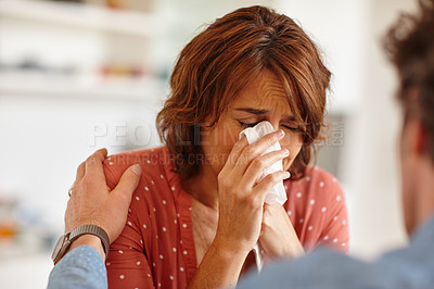 Buy stock photo Cropped shot of a woman being comforted by her husband as she cries