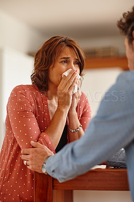 Buy stock photo Cropped shot of a woman being comforted by her husband as she cries