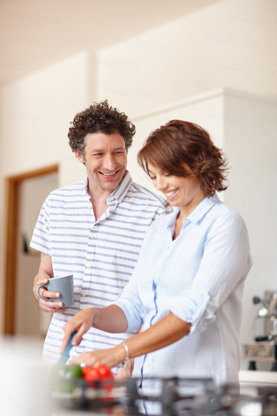 Buy stock photo Shot of a happy mature couple cooking a healthy meal together at home