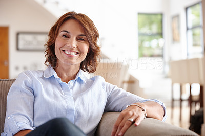 Buy stock photo Portrait of a mature woman sitting on her sofa at home