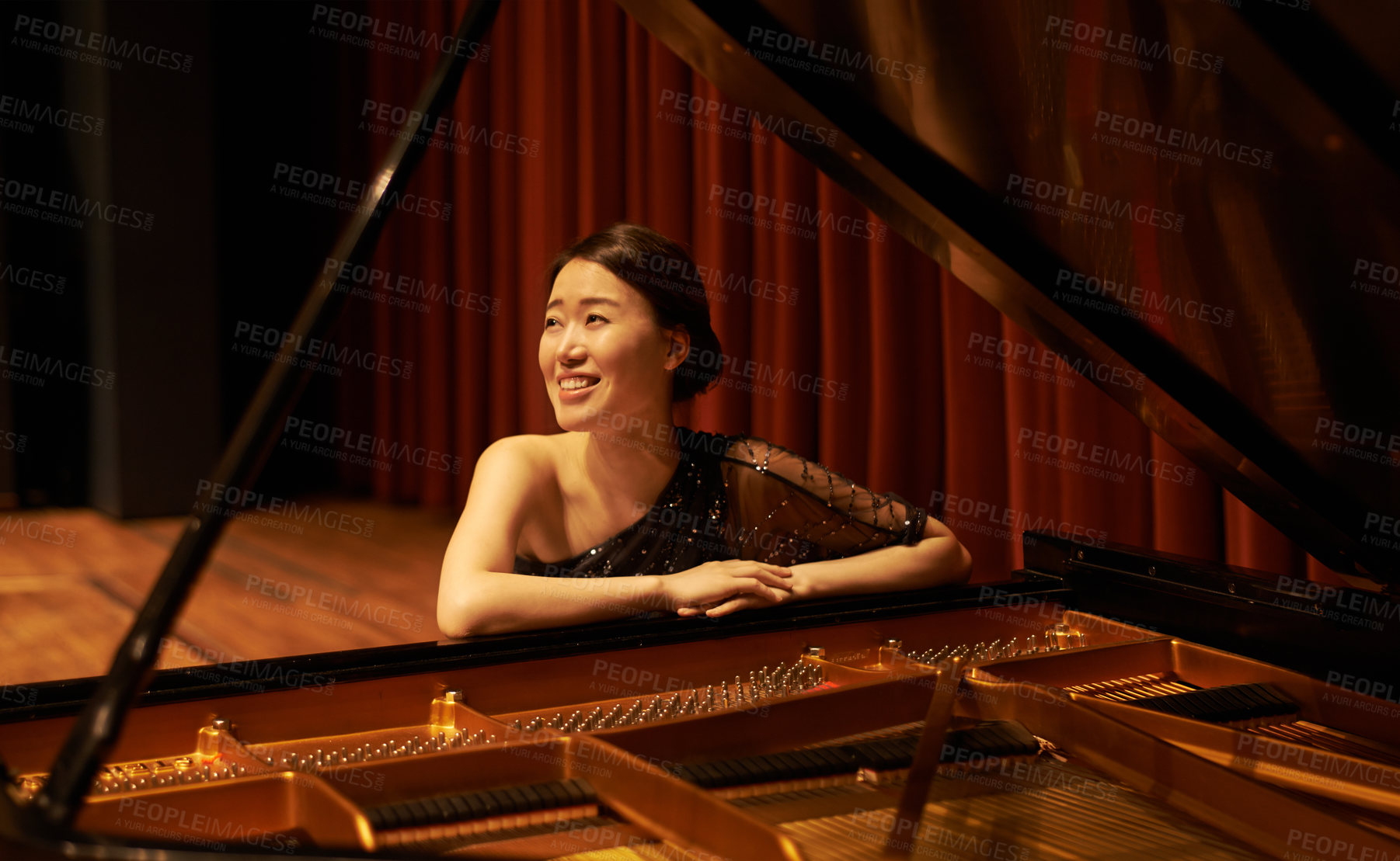 Buy stock photo Shot of a young woman sitting by her piano at the end of a musical concert