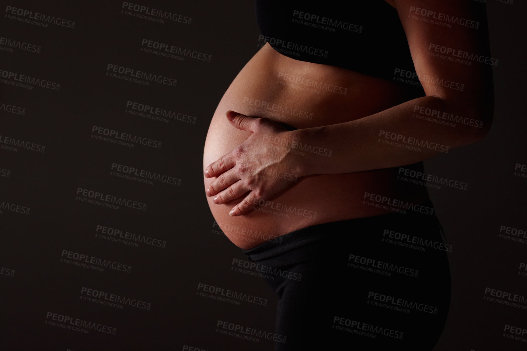 Buy stock photo Stomach, pregnancy and hands of woman on dark background for baby, family and maternity. Pregnancy, gynecology and isolated person for health, wellness and motherhood for IVF treatment in studio