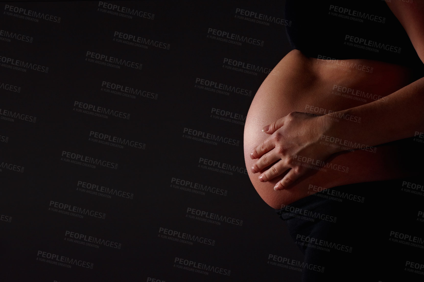Buy stock photo Stomach, pregnant and hands of woman on dark background for baby, family and maternity. Pregnancy, mockup space and isolated person for health, wellness and motherhood for IVF treatment in studio