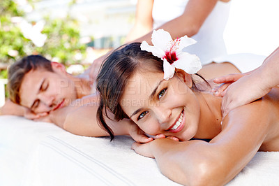 Buy stock photo Beautiful young couple receiving massages at a spa