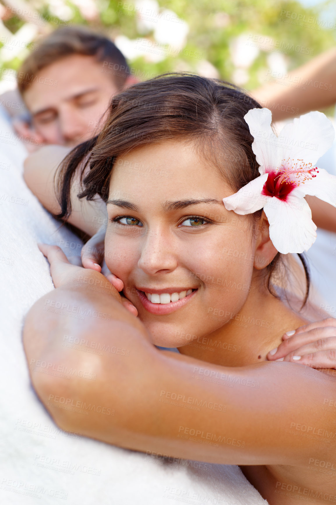 Buy stock photo Massage, relax and portrait of happy woman at spa outdoor for skin, health or wellness. Masseuse, face and couple at luxury salon with hibiscus flower in nature for natural beauty therapy on holiday