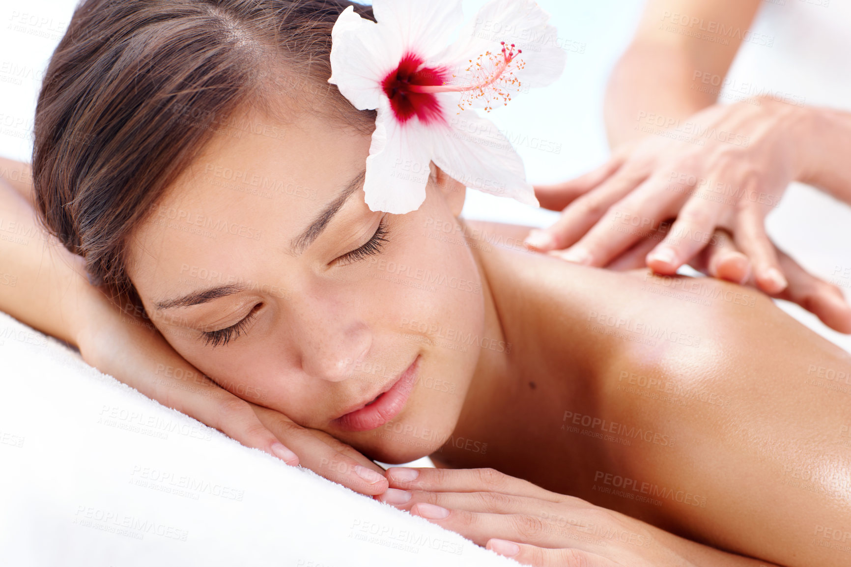 Buy stock photo Back massage, relax and woman at spa for health, skincare and calm for wellness on table. Masseuse hands, beauty and girl at salon with natural hibiscus flower holistic healing, peace and treatment