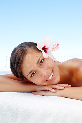 Buy stock photo Rest, portrait and woman with smile, massage or ready for luxury to relax in spa of hotel, vacation or wellness. Holiday, girl and outdoor on blue sky, treatment or stress free with flower in Hungary