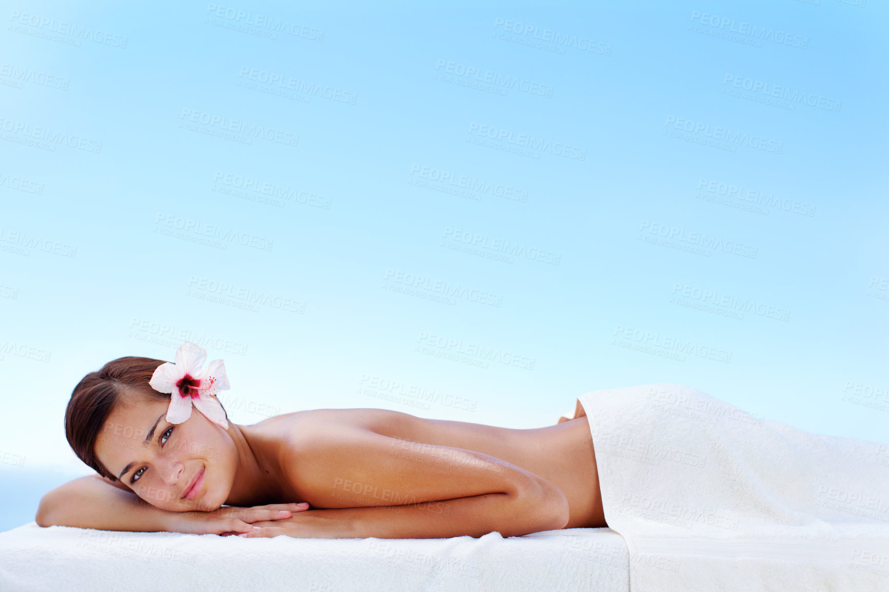 Buy stock photo Towel, portrait and massage for woman, outdoor and ready for luxury to relax in spa of hotel, vacation and wellness. Holiday, girl and space in paradise, treatment and rest with flower in Hungary