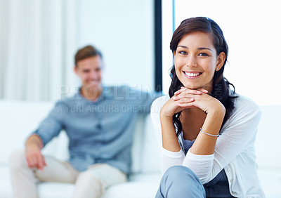 Buy stock photo Pretty young woman smiling with man in living room