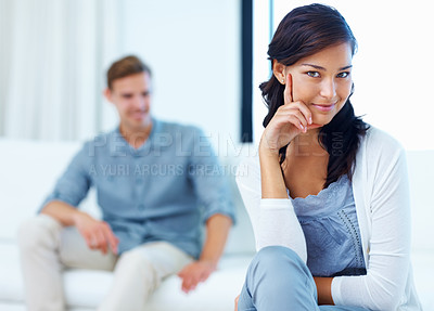 Buy stock photo Focus on beautiful young woman smiling with man in living room