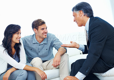Buy stock photo Young couple discussing financial plan with personal advisor at home