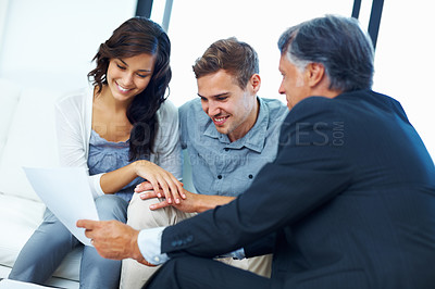 Buy stock photo Happy couple, financial advisor and paperwork in house for mortgage, investment and broker. Woman, man and consultant for insurance agency with cover, agreement and consultation for wealth planning