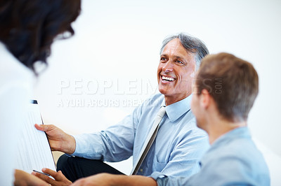 Buy stock photo Happy male advisor showing financial plan to clients