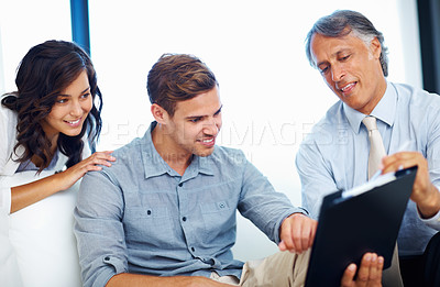 Buy stock photo Mature male advisor explaining savings plan to happy couple at home