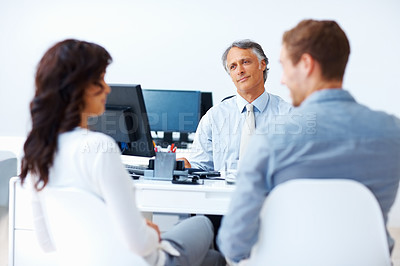 Buy stock photo Young couple meeting male advisor in office