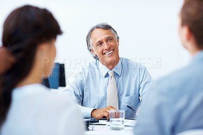 Buy stock photo Happy mature advisor having discussion with clients in office