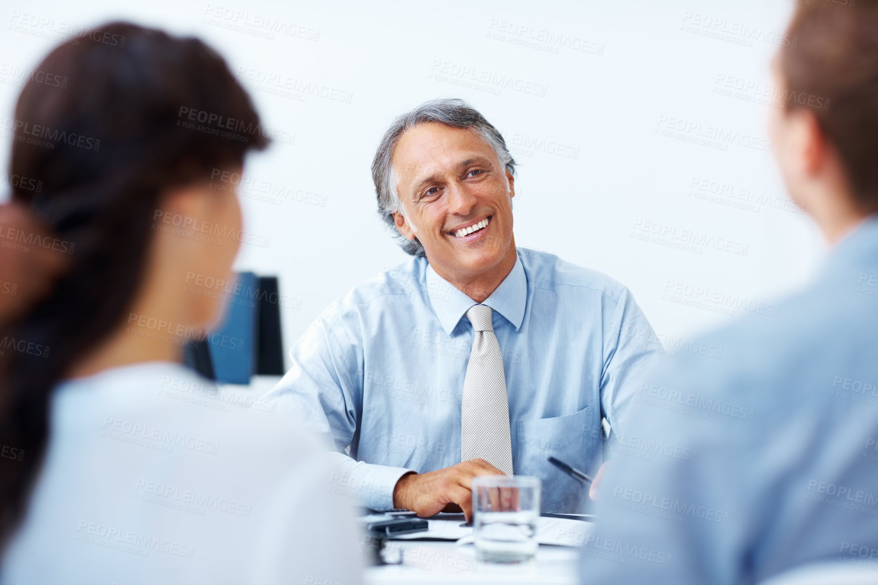 Buy stock photo Happy mature advisor having discussion with clients in office