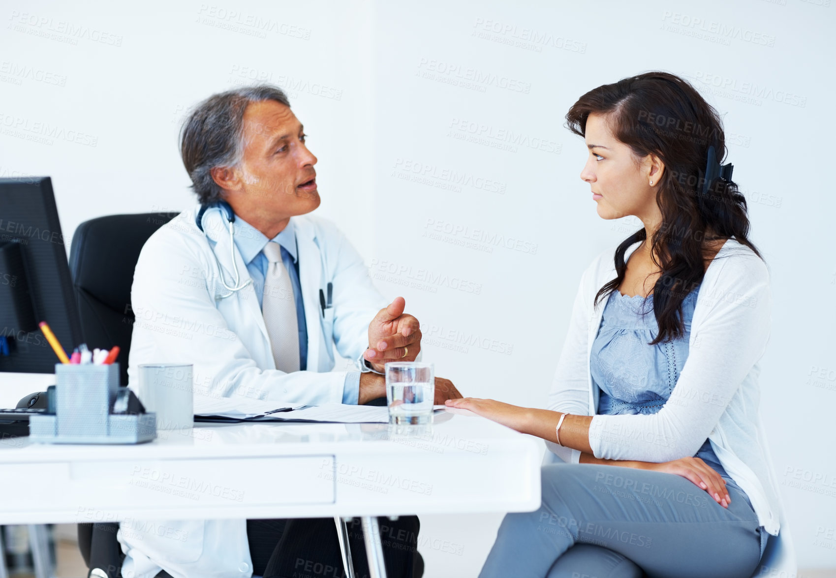 Buy stock photo Woman, patient and doctor with discussion at office for medical consultation on feedback or report for healthcare. People, man and gynecologist with file or folder in conversation for test results