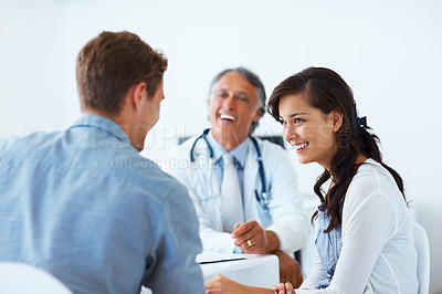 Buy stock photo Portrait of happy doctor and young patients having a healthy conversation in clinic