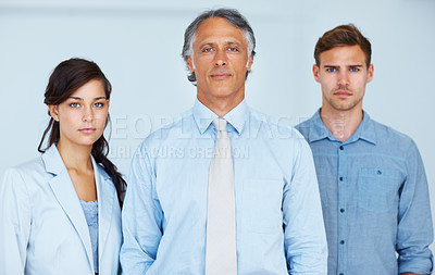 Buy stock photo Portrait of young business team with mature business man leading the group