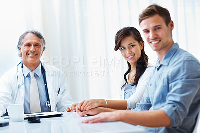 Buy stock photo Senior doctor, portrait and couple for consultation, healthcare or fertility advice at hospital. People, gynecologist or medical professional in meeting, discussion or planning for IVF treatment