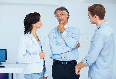 Buy stock photo Portrait of young business people listening to their mature leader in office