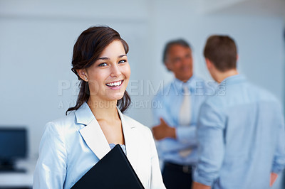 Buy stock photo Portrait of beautiful business woman smiling with associates discussing in background