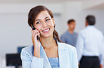 Young female executive talking on cellphone office