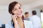 Business woman on cellphone with staff in background