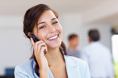 Buy stock photo Closeup of happy business woman talking on mobile phone with staff in background