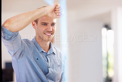 Buy stock photo Portrait of smiling young man looking out through glass