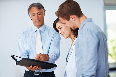 Buy stock photo Couple, financial advisor and document in office for discussion, planning and budget management for future. Reading, man and woman with lawyer for legal advice, mortgage and compliance with paperwork