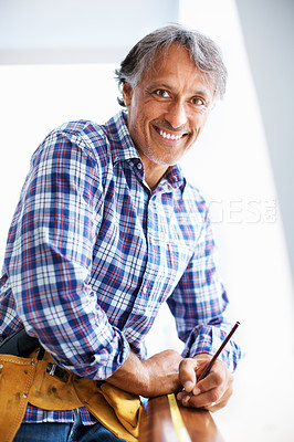 Buy stock photo Portrait of mature architect smiling while working with tape measure