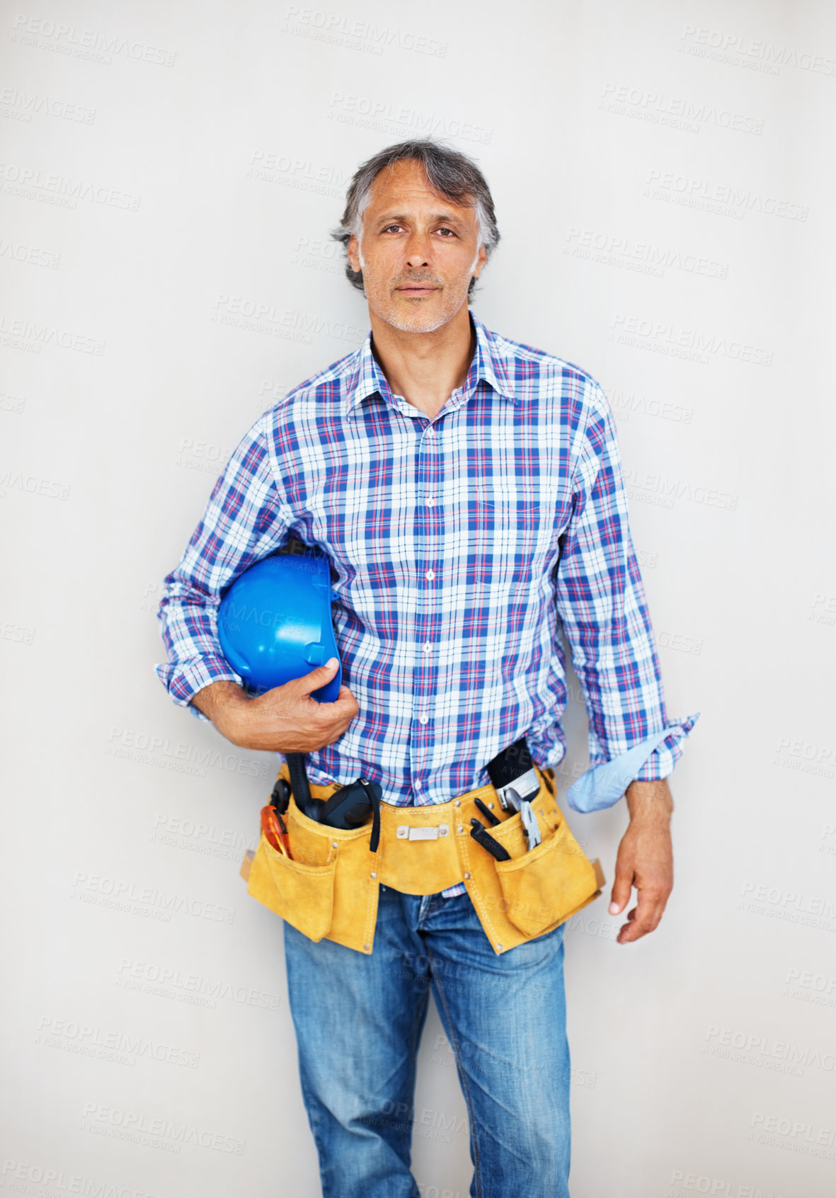 Buy stock photo Portrait, tools and man with helmet, studio and serious for handyman for renovation and working in project. White background, entrepreneur and ready for maintenance, construction and business