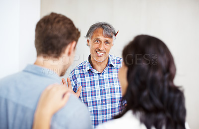 Buy stock photo Focus on mature architect in conversation with young couple