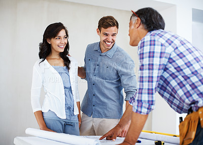 Buy stock photo Happy couple discussing home renovation plan with architect