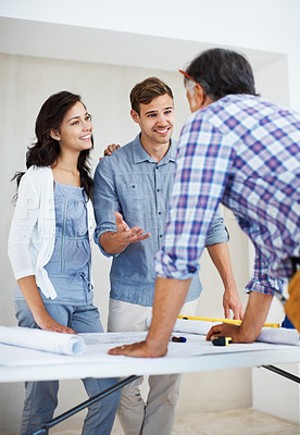 Buy stock photo Happy young couple discussing home renovation plan with architect