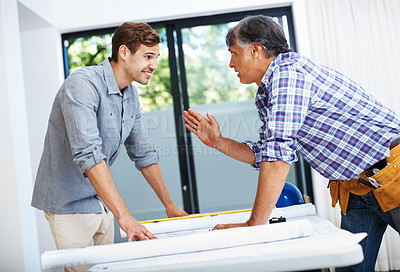 Buy stock photo Mature contractor discussing with young man in office