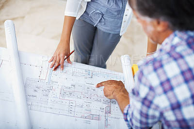 Buy stock photo Closeup of architect showing plan to female client