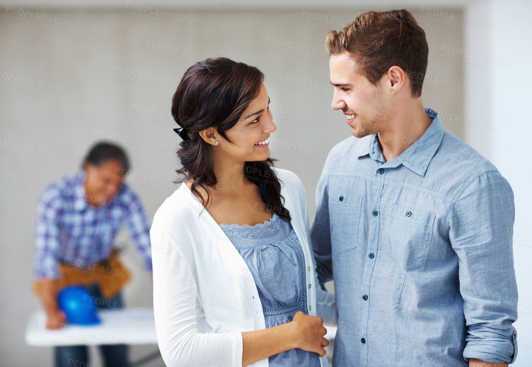 Buy stock photo Couple, talking and happy in workplace with architect for new house, advice and client feedback. Man, woman and smile in office building for planning design, home renovation and project timeline