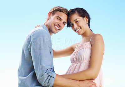 Buy stock photo Portrait, couple and hug with love by blue sky for marriage commitment, romance and holiday of date outdoor. Smile, woman and man with embrace for engagement proposal, vacation trip or trust together