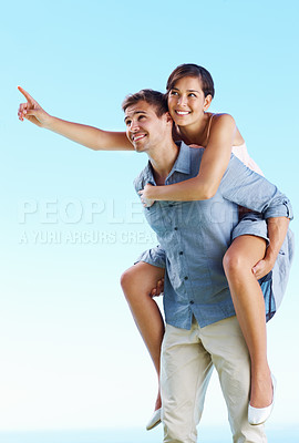 Buy stock photo Outdoor, couple and happy with hug with pointing for love, trust and support in Spain. People, relationship and smile in rooftop for care on holiday or vacation for honeymoon, relax and break for fun