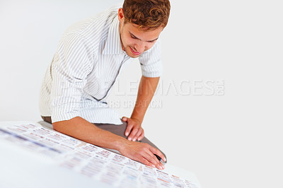 Buy stock photo Male photographer sitting on table and looking at his photos