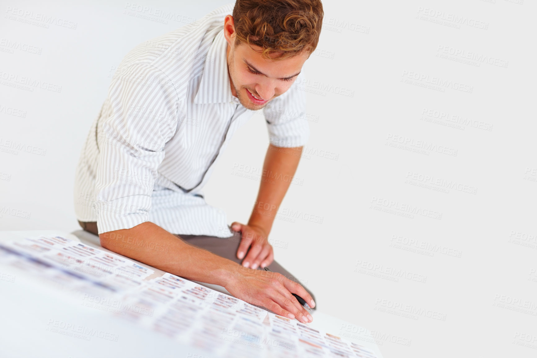 Buy stock photo Male photographer sitting on table and looking at his photos