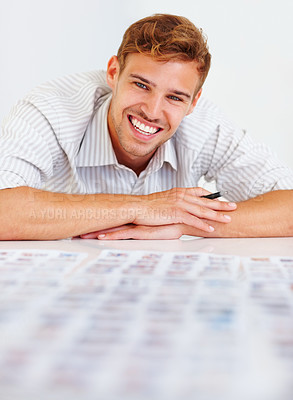 Buy stock photo Portrait of happy male photographer sitting at table and looking at his photos