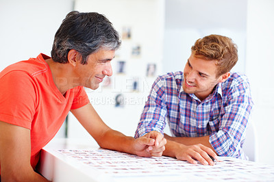 Buy stock photo Professional photographers sitting at table and discussing