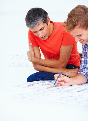 Buy stock photo Two professional photographers discussing at work