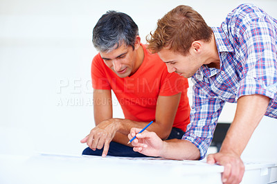 Buy stock photo Two male photographers in discussion during work